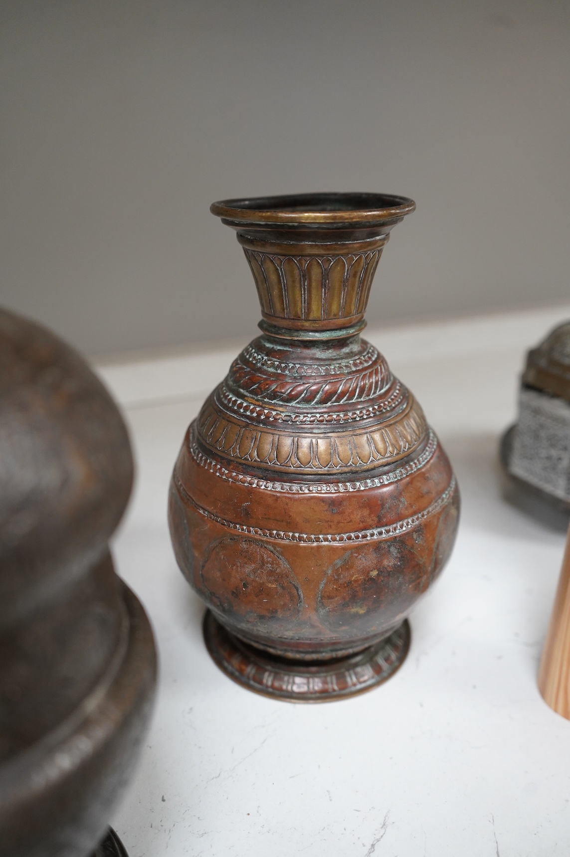 A collection of Persian, Eastern and Chinese metalware to include two brass tripod censers, pair of vases and an enamel bowl, largest 33cm high